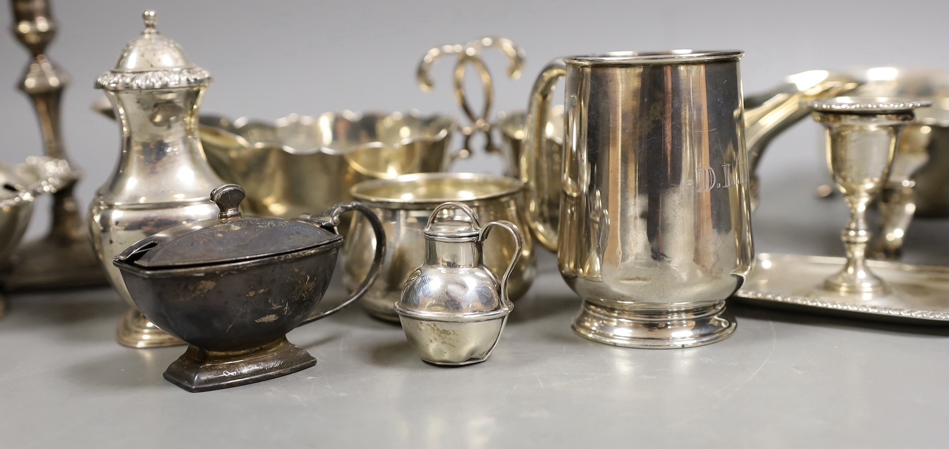 A pair of late Victorian silver sauceboats, Frederick Augustus Burridge, London, 1899, a George V silver mounted taperstick, a modern silver three piece condiment set, a silver chamberstick, silver mug, two silver small